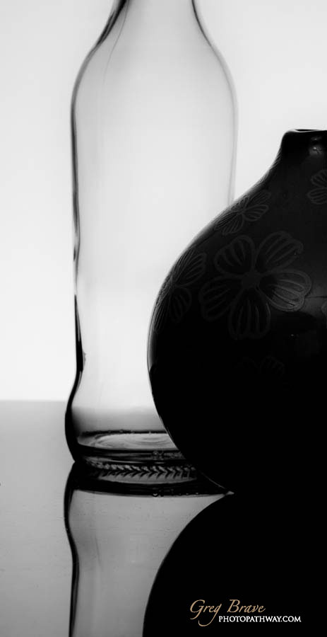 Still life with bottle and vase in black and white by greg brave