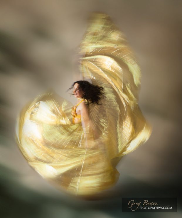 Ethereal beautiful woman swirling in a dance move