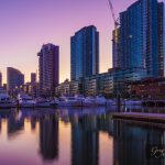 Docklands, Melbourne high rise residential buildings and moored yachts at dawn