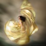 Ethereal beautiful woman swirling in a dance move