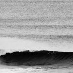 Closeup of a breaking wave in black and white