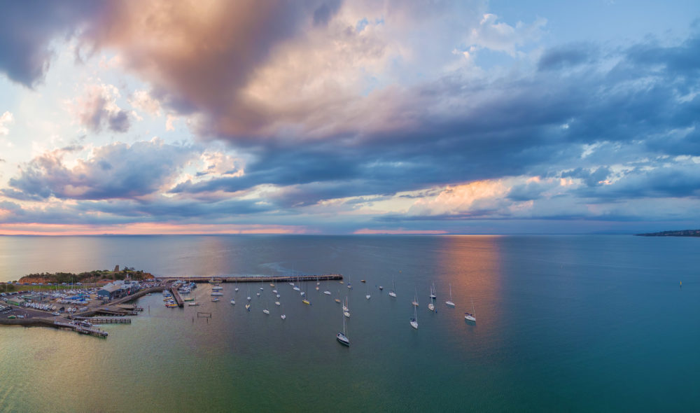 Cloudy sunset over Mornington pier and yachts in Australia