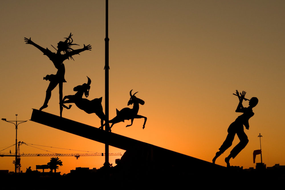Modern fairy-tale themed sculpture silhouette at sunset